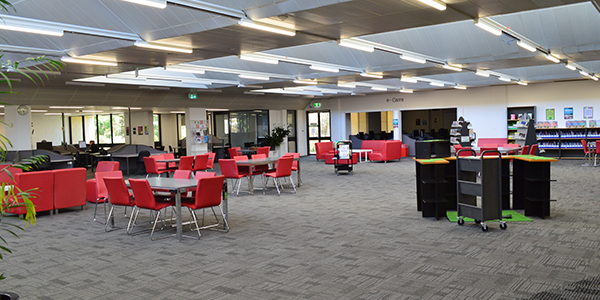 Large library with red tables and chairs