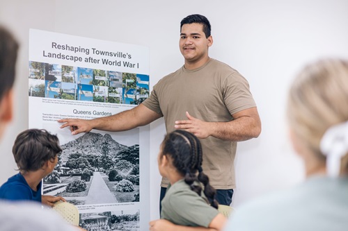 Photo: a student teaching kids about the 'reshaping of Townsville's landscape after World War One' 