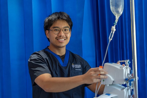 Photo: a nursing student checking medical equipment. Credit: Budd Photography
