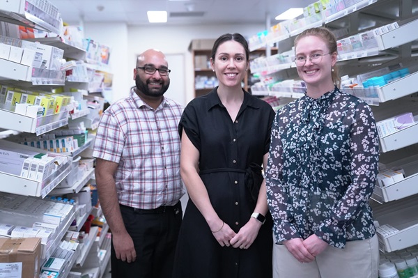 Photo: three pharmacists standing in a dispensary