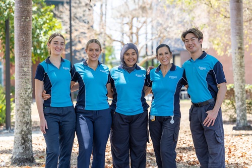 Photo: a group of nusing students smiling. Credit: Budd Photography